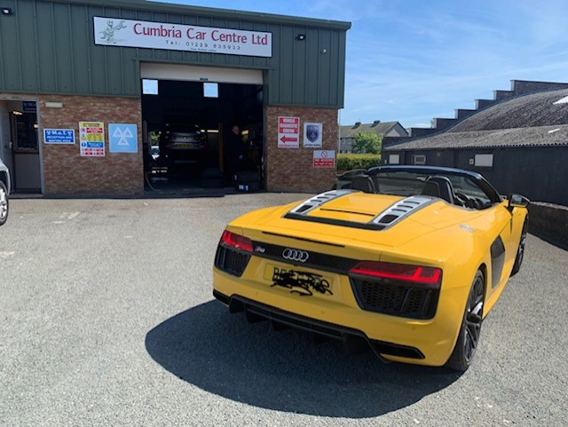 The Cumbria Car Centre shop front with MOT signs above the workshop door