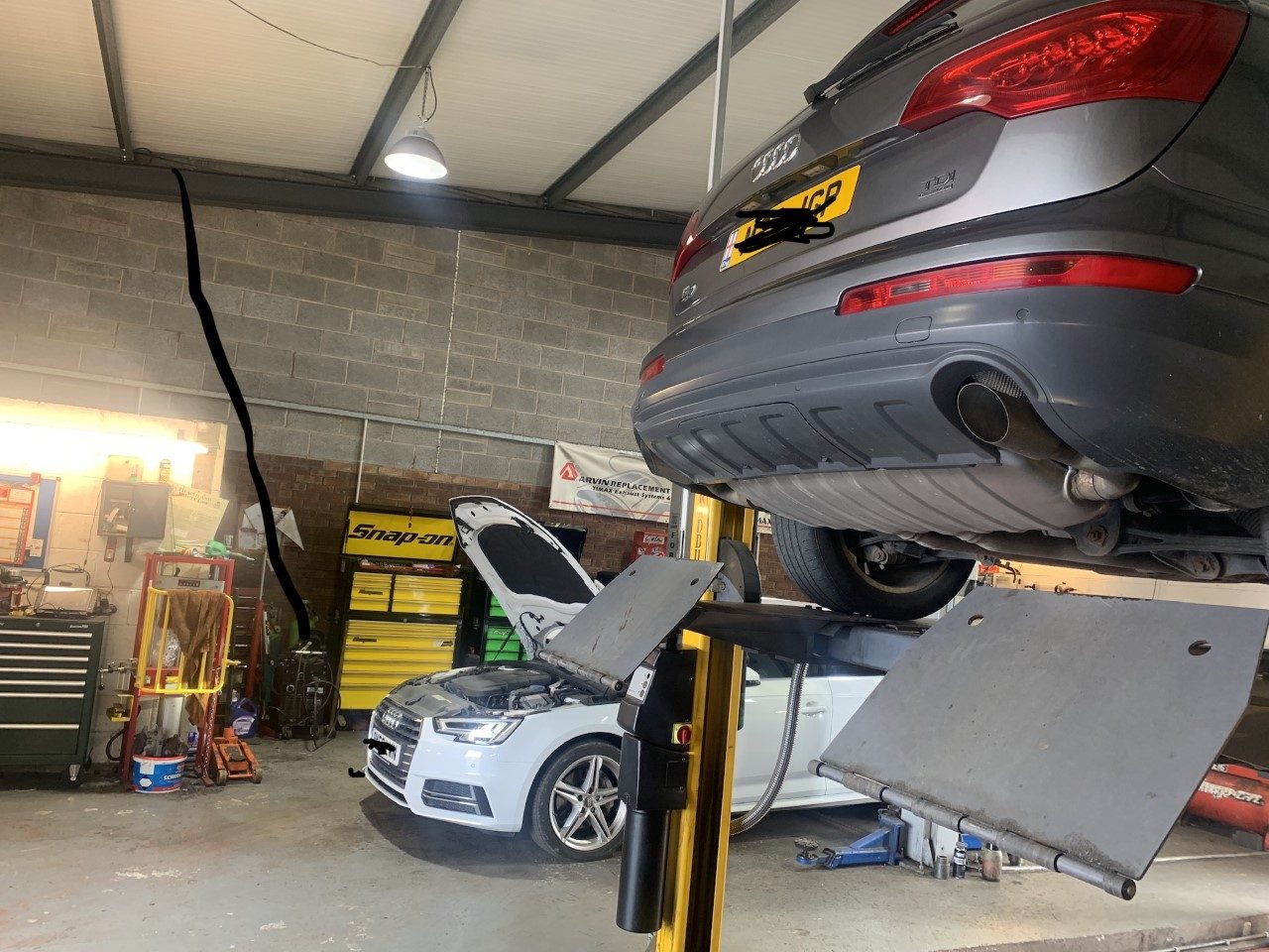 Inside the Cumbria Car Centre workshop: an Audi raised on the lift with the tool chests behind